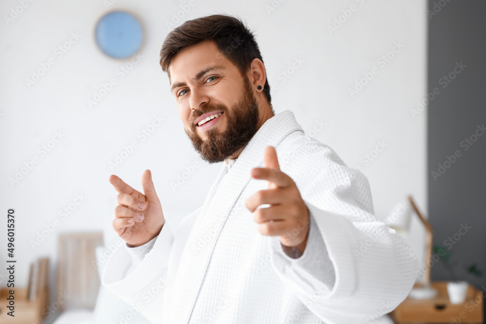 Wall mural Handsome man in bathrobe dancing at home