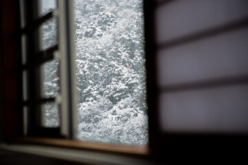 Mountain covered with snow in Japan through Japanese shoji window