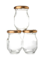 Empty glass jars with golden caps on white background