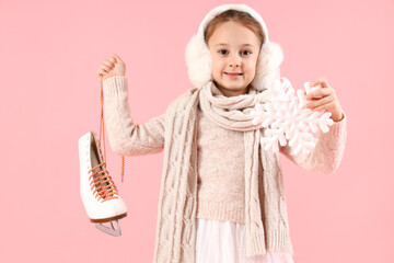 Cute little girl in winter clothes, with ice skate and snowflake on color background