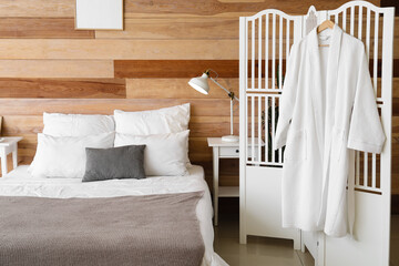 Interior of modern bedroom with wooden wall