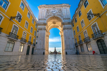 Rua Augusta Arch at sunrise in Lisbon, Portugal. Statue of King Jose I on Commerce Square at the...