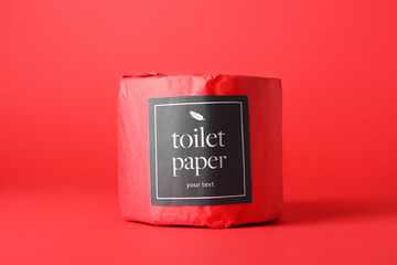 Toilet paper roll on red background