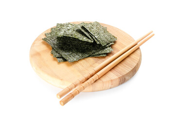 Wooden board with tasty seaweed sheets and chopsticks on white background © Pixel-Shot
