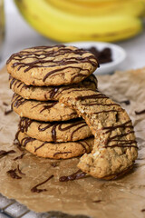 banana oatmeal cookies with chocolate chips, bananas in background