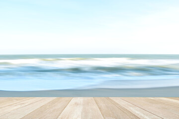 Fototapeta na wymiar Empty top wooden table on soft focus blurred sea beach for background