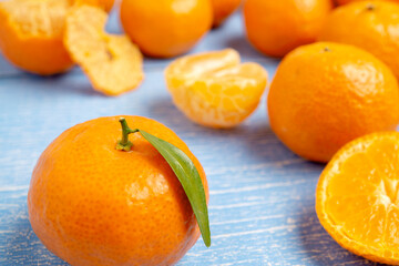 Organic Jeruk Baby Santang or Mandarin Baby Oranges, very sweet and juicy, on wooden blue background
