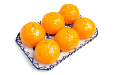 Fresh Organic Jeruk Baby Santang or Mandarin Baby Oranges, very sweet and juicy, serving on blue plate isolated on white background. Clipping path