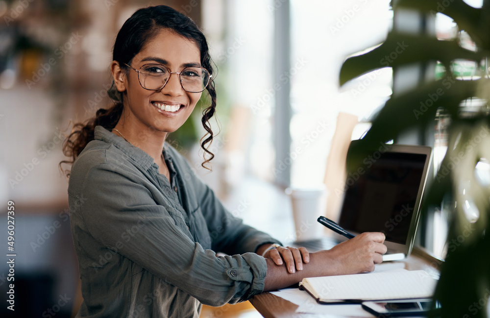 Canvas Prints For flexible working hours try freelancing. Shot of a young woman working in a cafe.