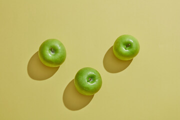 Top view of green apple in green background for advertising 