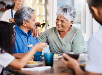Hey, were in company. Shot of a happy family having lunch together at home.