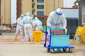 medical workers transfer nucleic acid test specimens to the mobile shelter of medical laboratory,...