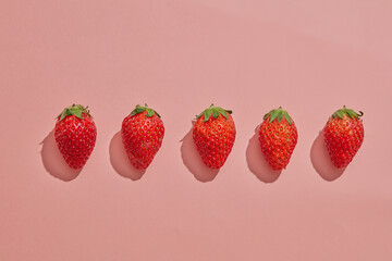 Top view of strawberry decorated in pink background for advertising