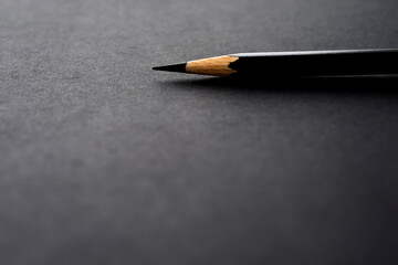 Black pencil on black background