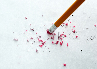 Pencil erasing mistake on white background