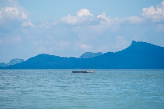 Landscape image of a wooden floating pontoon in the sea with the islands and blue sky in Koh Yao, Phang Nga, Thailand