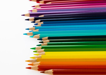 Fototapeta premium A row of colorful pencils on white background