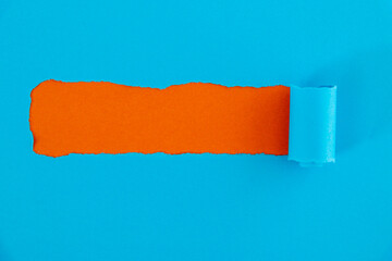 Blue torn paper on orange background
