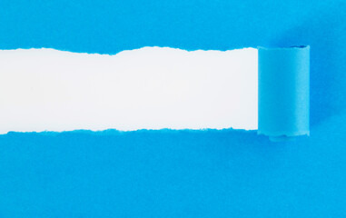 Blue torn paper on white background