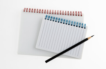 Pencil and notebooks on white background