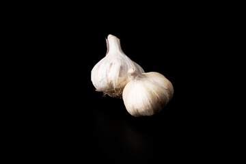 Garlic head on a black background. Healthy and vegetarian food