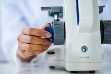 Getting an even closer look. Cropped shot of an unrecognizable female scientist working in her lab.