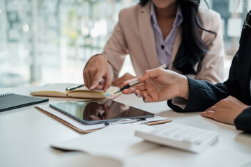 Business people discussing and consulting marketing plan at exclusive meeting room.