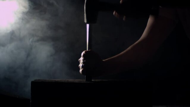 Hammer hitting a big nail in a dramatic misty ambience