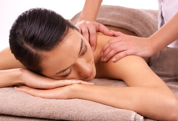 Fototapeta na wymiar Stress be gone. Shot of a beautiful young woman enjoying a relaxing massage.