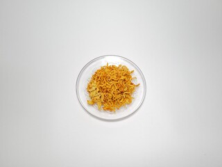 Spicy macaroni and spicy crispy noodles isolated on white and gray combination