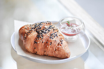 croissant , French croissant or French bread with sesame topping and  strawberry dip