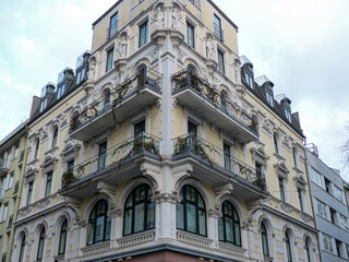 Fototapeta na wymiar Building with balcony on the corner