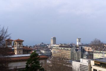 Fototapeta na wymiar Aerial view over City of Lausanne seen from terrace named Esplanade du Château at on a cloudy spring day. Photo taken March 18th, 2022, Lausanne, Switzerland.