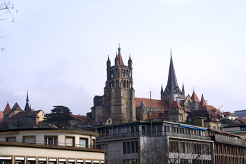 Medieval Cathedral Notre Dame at the old town of Lausanne on a blue and gray cloudy spring day. Photo taken March 18th, 2022, Lausanne, Switzerland.