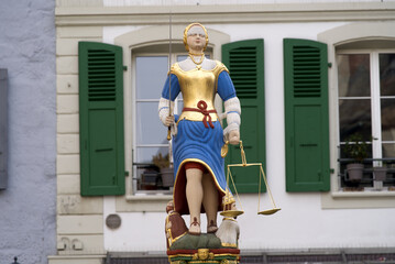 Fountain of justice built 1585 at Square named Place da la Palud at the old town of Lausanne on a cloudy spring day. Photo taken March 18th, 2022, Lausanne, Switzerland.