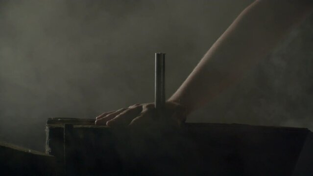 Hammer hitting a big nail in a dramatic misty ambience