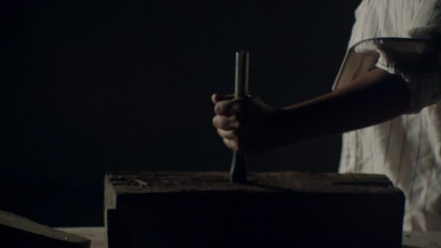 Hammer hitting a big nail in a dramatic misty ambience