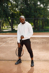 Black man with racquet pose on court