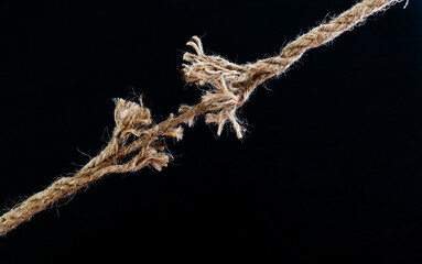 Broken rope on black background - obrazy, fototapety, plakaty