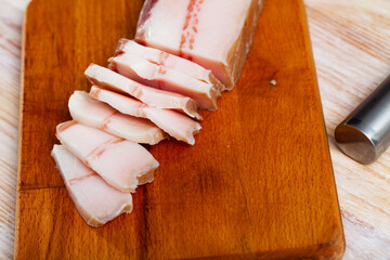 Appetizing salted pork belly on a cutting board. High quality photo