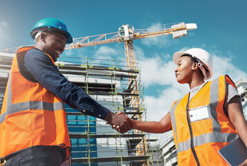 The perfect blend of construction skills and collaborative skills. Shot of two builders shaking hands at a construction site. - Powered by Adobe