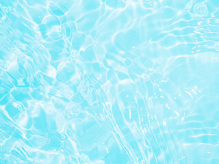 Ripple water texture on blue pool background. Shadow of water on sunlight. Mockup for product, spa...