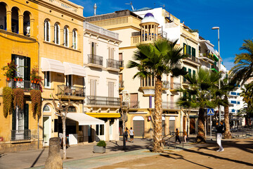 SITGES, CATALONIA, SPAIN - November 18, 2020: View on pedestrian street with cafes and shops