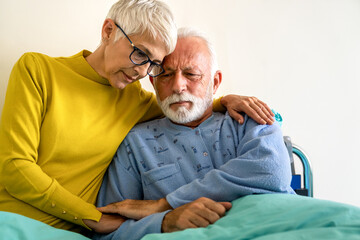 Senior woman with seriously ill husband in hospital. Healthcare support anxiety love concept - obrazy, fototapety, plakaty