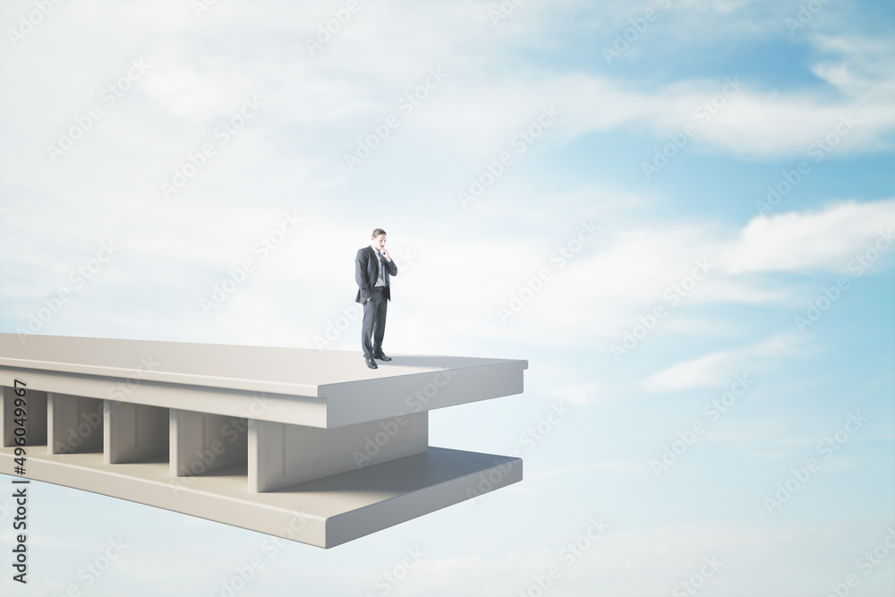 Aufkleber attractive pensive young man standing on bridge with gap and blue sky background with mock up place.