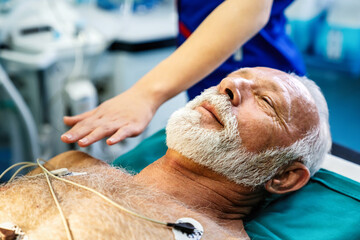 ECG electrodes on mature male patient in hospital before surgery. Healthcare and medicine concept