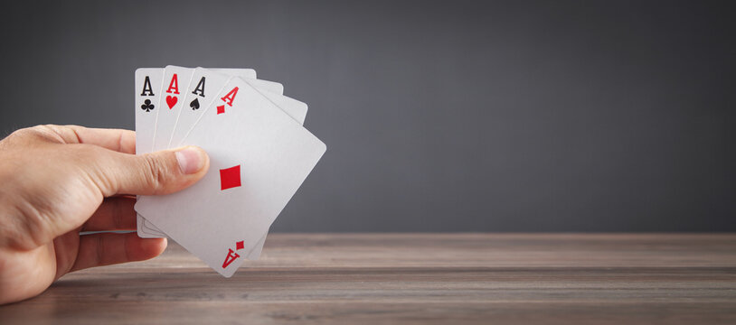 Male Hand Holding Playing Cards.