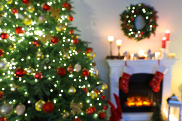 Fototapeta na wymiar Blurred view of decorated room with Christmas tree and fireplace