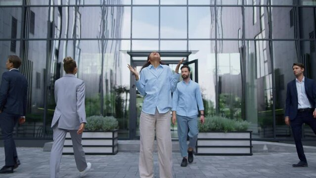 Successful corporate worker celebrating triumph laughing in urbanistic workplace