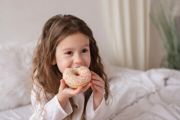 little girl eating a donuts